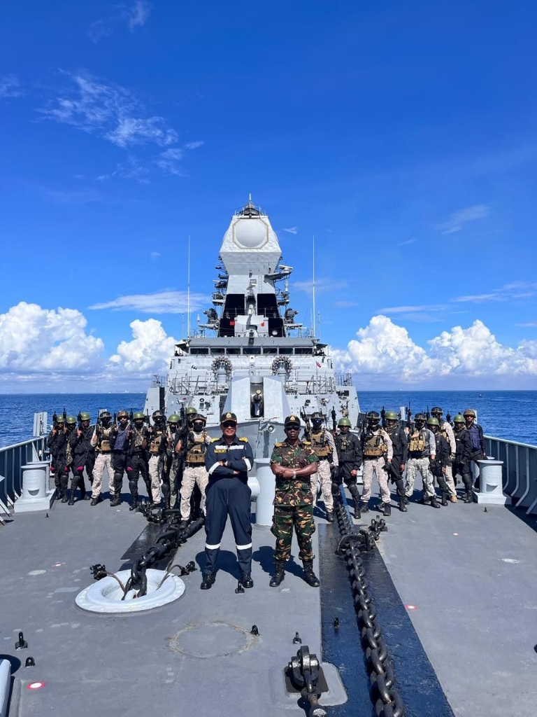 MARCOS commando operators assembled on warship deck utilizing defence electronics and maritime situational software