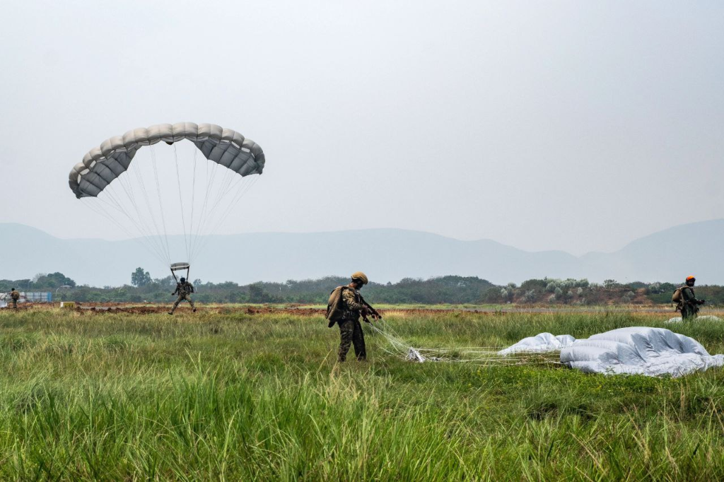 Airborne insertion operation demonstrating military automation and tactical coordination